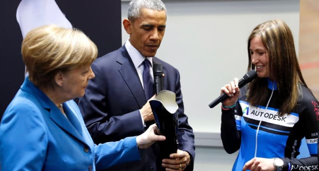Paralympics cycling champ Denise Schindler with then-U.S. President Barack Obama, and Germany’s chancellor Angela Merkel at Hannover Messe trade fair in 2016. (Image courtesy of USA Today.)