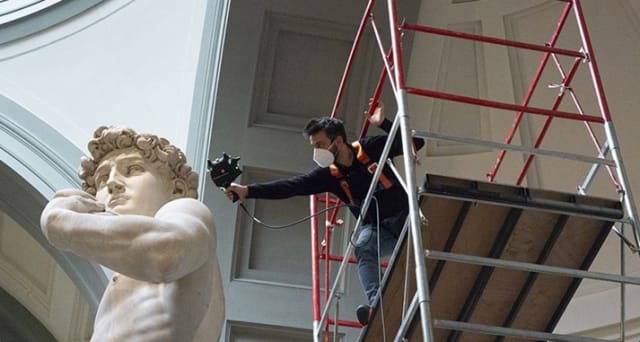 A Hexagon staff member uses the AT960 to scan David’s ears. The scanning alone took two workers more than 10 days to complete. Staff had to use scaffolds to hand-scan sections of the statue while being several feet high. (Image courtesy of Hexagon.)