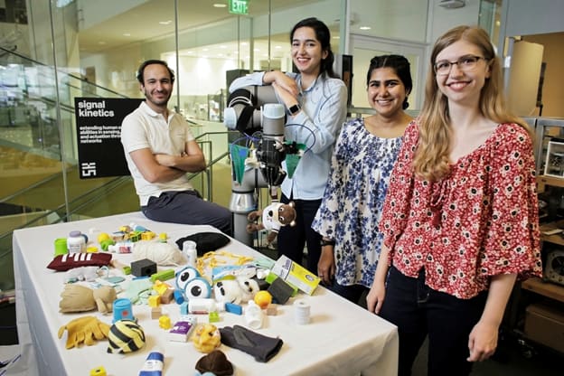 Engineering graduate student research assistants at MIT’s Signal Kinetics group are working on FuseBot in the MIT Media Lab. Left to right: Fadel Adib, director of the Signal Kinetics group and associate professor in the Department of Electrical Engineering and Computer science; Tara Boroushaki, B.S. Electrical Engineering and a graduate student at MIT Media Lab; Nazish Naeem, B.S. Electrical Engineering; and Laura Dodds, B.S. Electrical Engineering & Computer Science. (Image courtesy of MIT.)