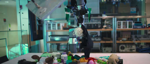 The robotic arm retrieving the target item from a pile of household objects. (Source: MIT.)