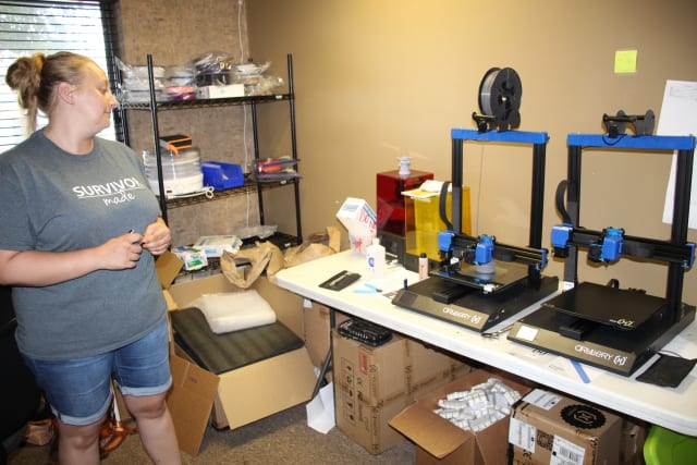 Glotz and two of the Artillery Sidewinder 3D printers used in the Refuge for Women AM program. (Image courtesy of Refuge for Women.)