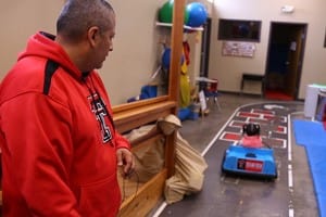 Ava drives away as her father watches. (Image courtesy of Texas Tech University.)
