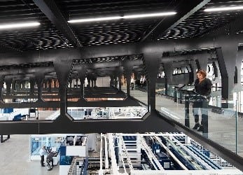 A skywalk spans the production hall, offering a bird’s-eye view of the factory and giving those who walk on it an overview of the production equipment, as well as their material and information flows. (Image courtesy of Trumpf.)