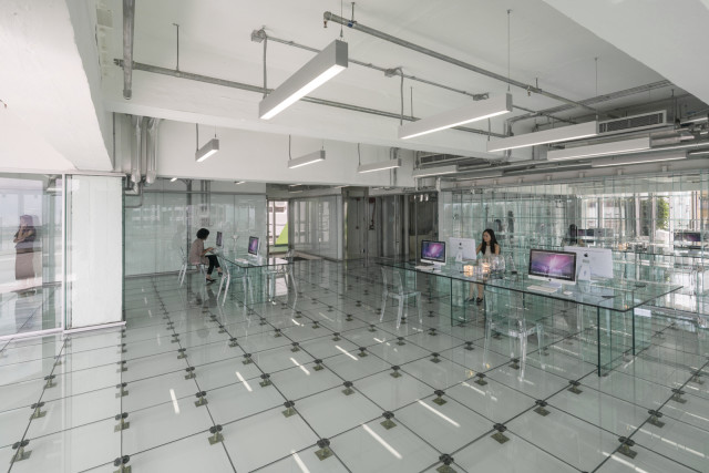 A model office outfitted with glass furniture puts the emphasis on glass as a metaphor for an open business model. (Image courtesy of MVRDV.)