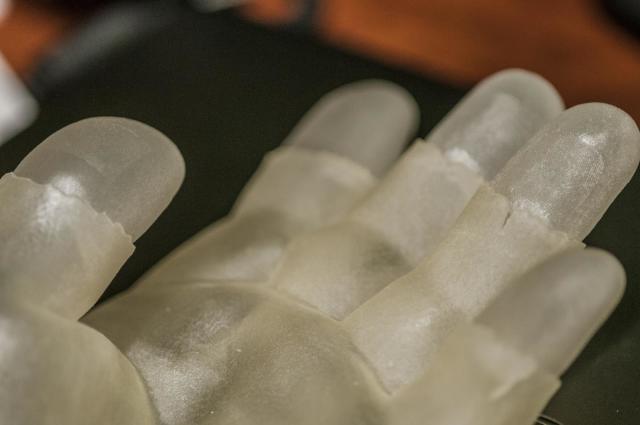 MSU researchers demonstrate how a 3-D printed model hand is used to test a fingerprint scanner for accuracy. (Image courtesy of G.L. Kohuth.)