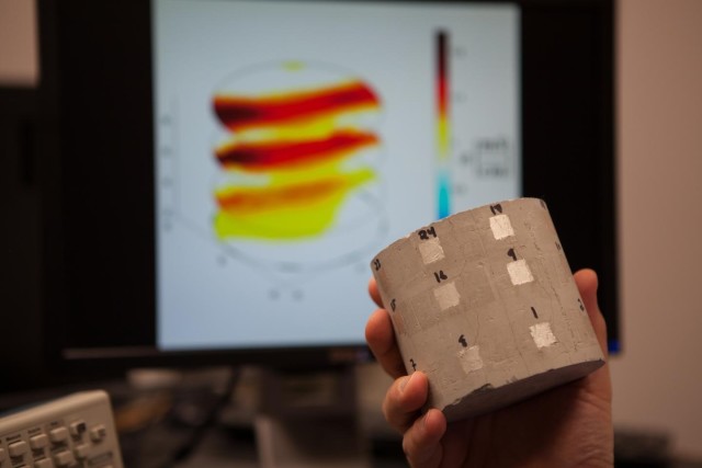 This photo shows one of the cracked samples tested in this work. The image in the background shows the flow of water in the cracks. (Image courtesy of Julie Williams Dixon.)