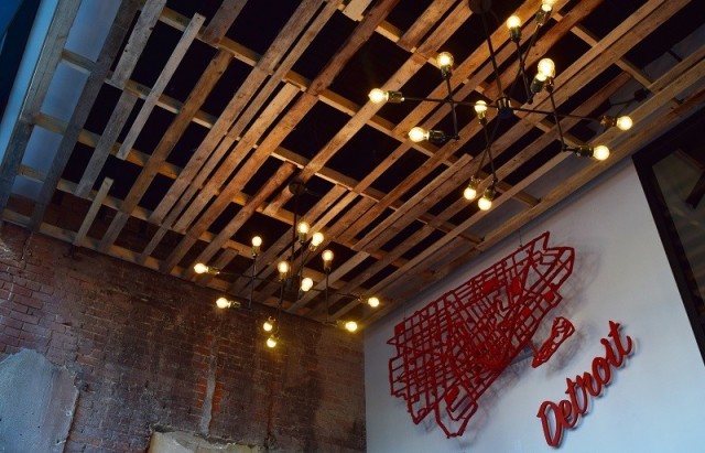 While the exterior has been restored close to its original Victorian Romanesque design, interior renovations exude an industrial Detroit style and aesthetic. (Image courtesy of Lear.)