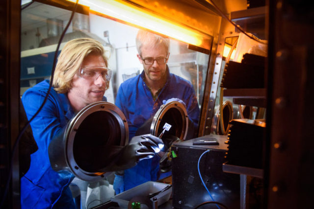Stanford post-doctoral scholar Tomas Leijtens and Professor Mike McGehee examine perovskite tandem solar cells. (Image courtesy of L.A. Cicero.)