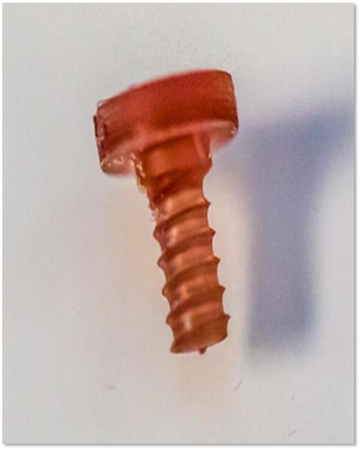 A silk fibroin screw fabricated with golden nanorods can be heated to 160 C when exposed to infrared light emitted by an LED. (Image courtesy of Tufts University.)