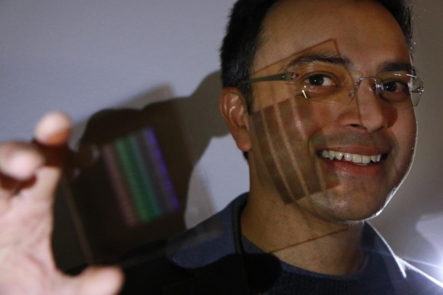 Professor Rajesh Menon showing the prototype of the first flat and thin camera lens. (Image courtesy of the University of Utah.)