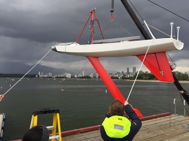 Figure 3.Ada was tested extensively in her home waters on the Pacific coast before attempting a Trans-Atlantic crossing. This photo shows MadieMelcer, mechanical team co-lead, hoisting Ada and the long, red keel that kept her upright through four months of North Atlantic storms. “We got the keel right … Satellite transmissions require a clear view of the sky, so the boat needs to be sufficiently upright,” said team co-captain Serena Ramley. (Image courtesy of the UBC Sailbot team.)