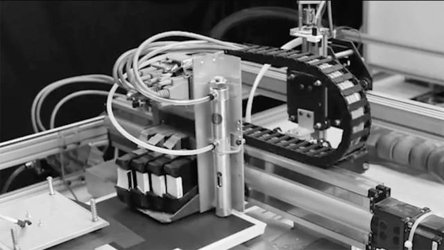 The CBAM inkjet head depositing the liquid solution. (Image courtesy of Impossible Objects.)