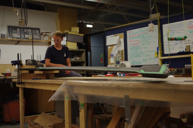 Figure 5. Alumni co-captain KristofferVik Hansen checking Ada’s keel deflection in a cantilever beam setup after construction. (Image courtesy of the UBC Sailbot team.)