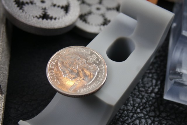 Industrial grade 3D Printers will cost you a few of these. Quarter pictured atop a stereolithography-printed part.