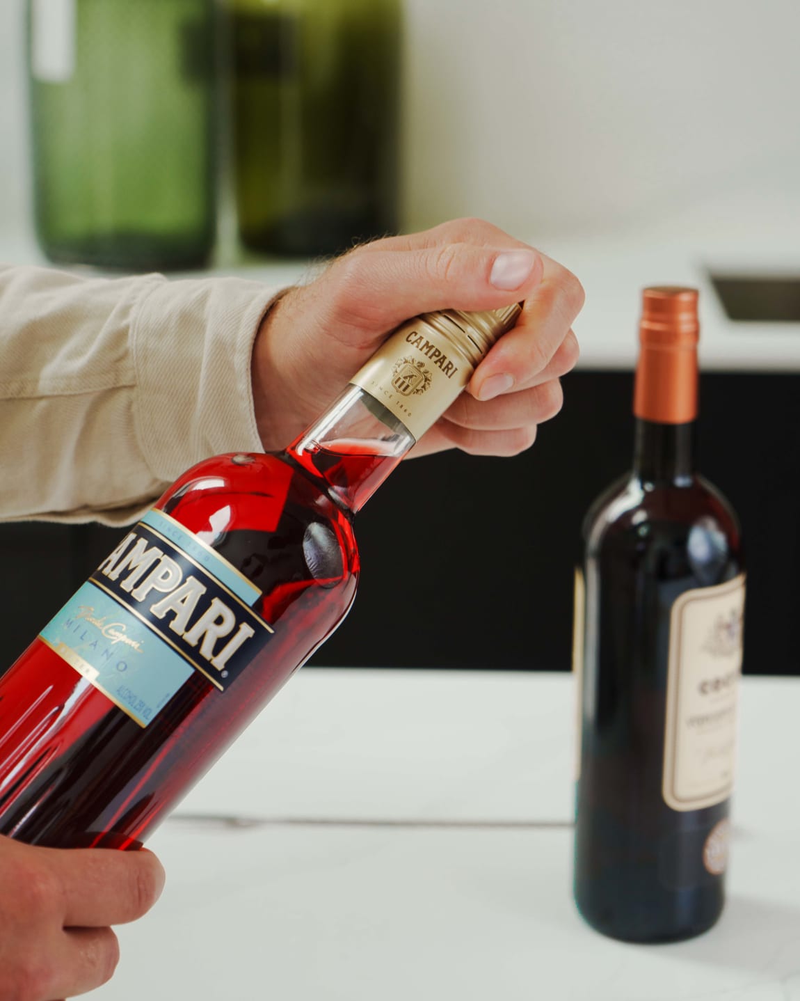 Opening a bottle of Campari