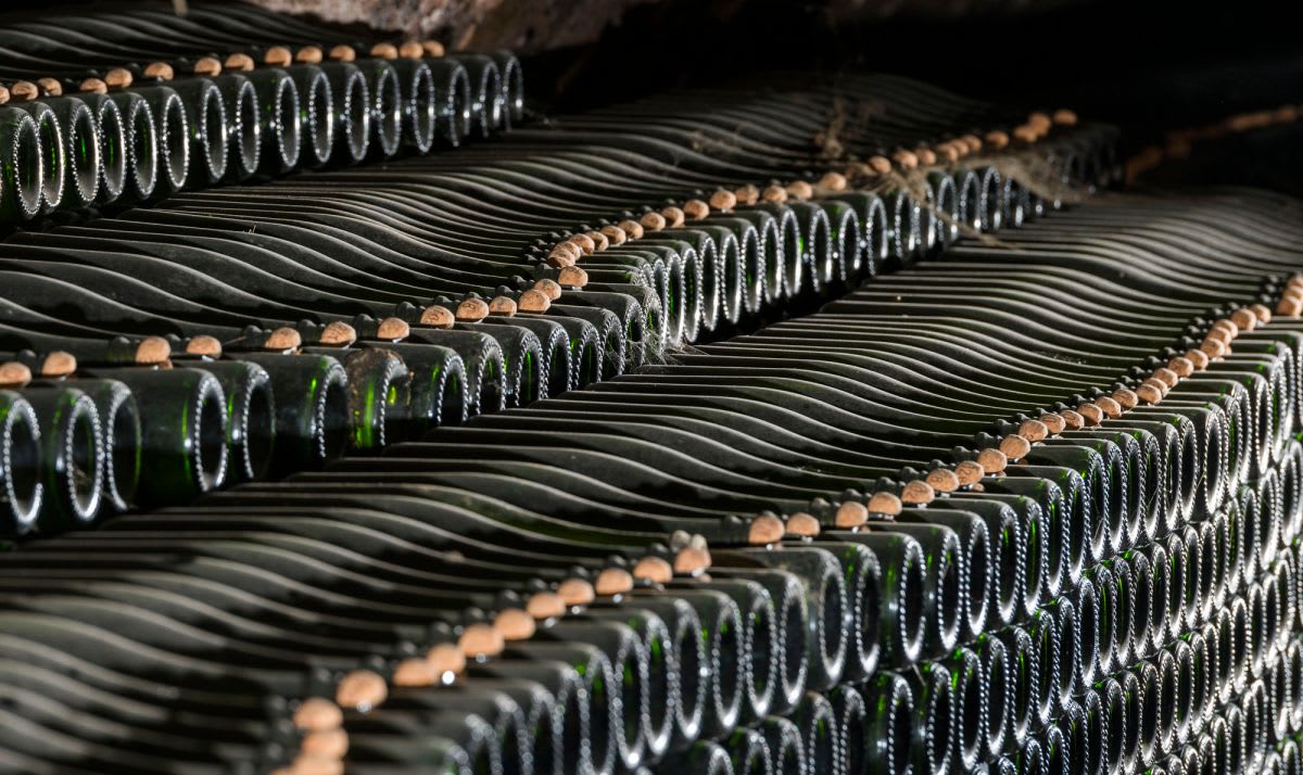 Bottles of Gramona Corpinnat laying down in cellar