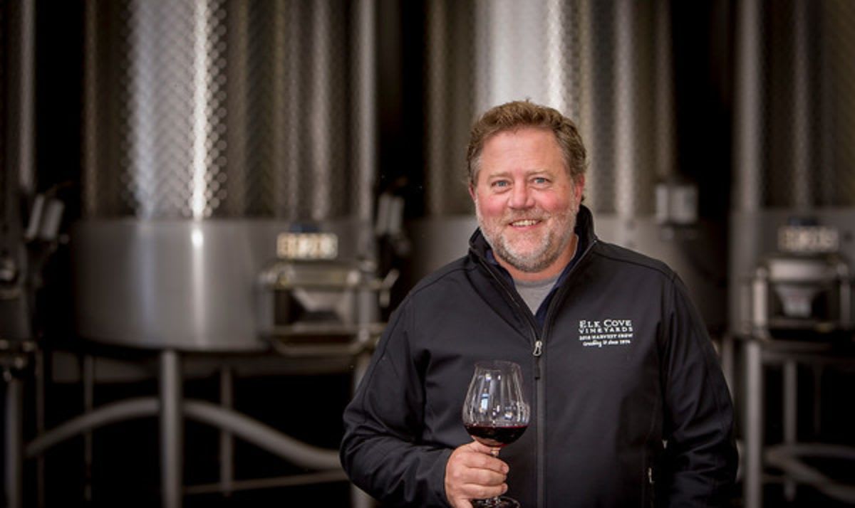 Winemaker at Elk Cove standing in front of steel wine tanks