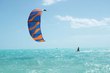 Kiteboarding above unending miles of flat turquoise water and white sandy beach, Provo