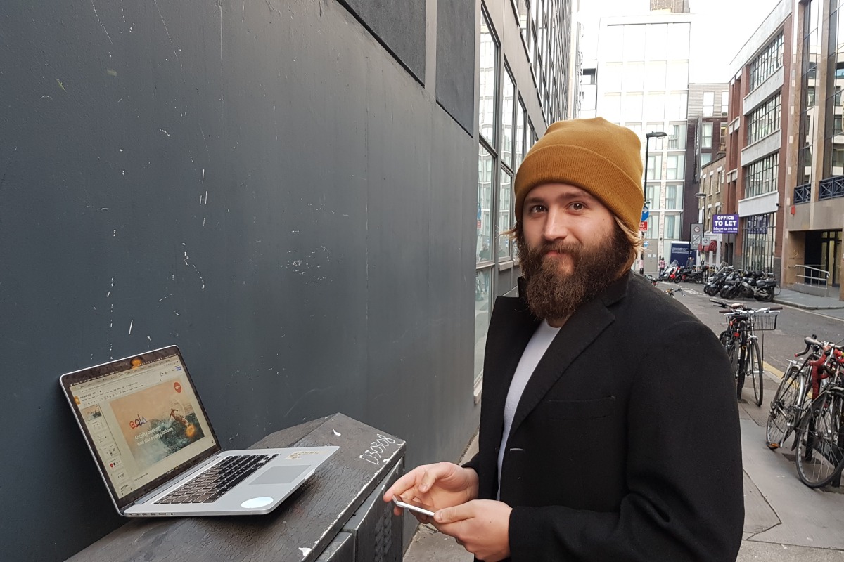 eola CEO, Callum Hemsley, working from a London sidewalk