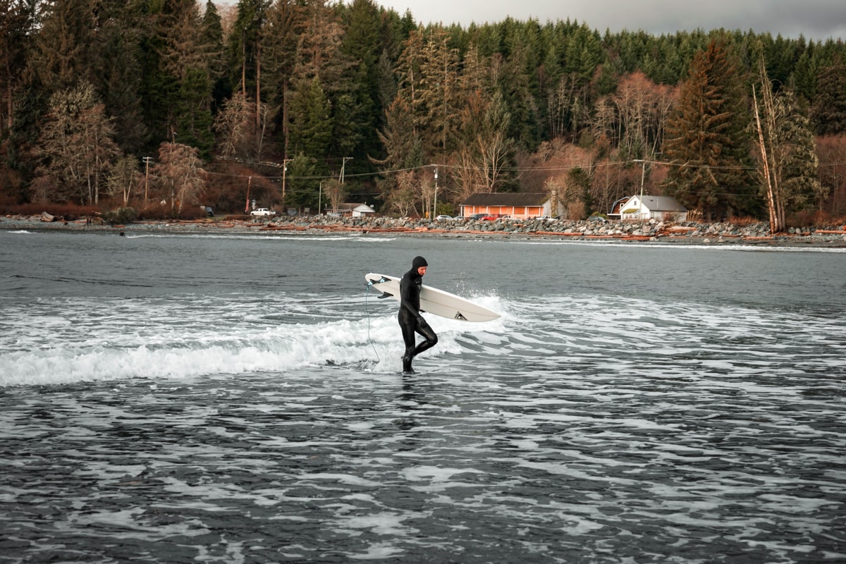 surfer walking out of surf