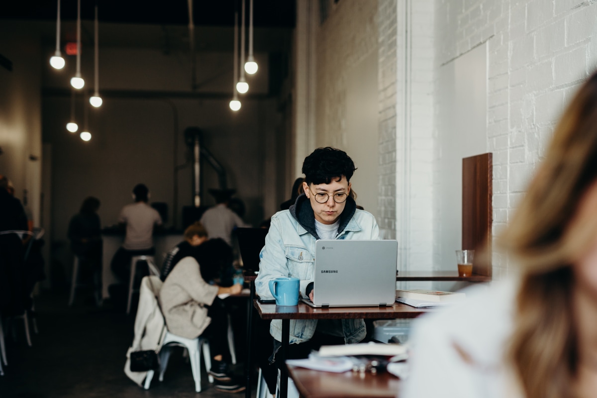 Woman on laptop in cafe