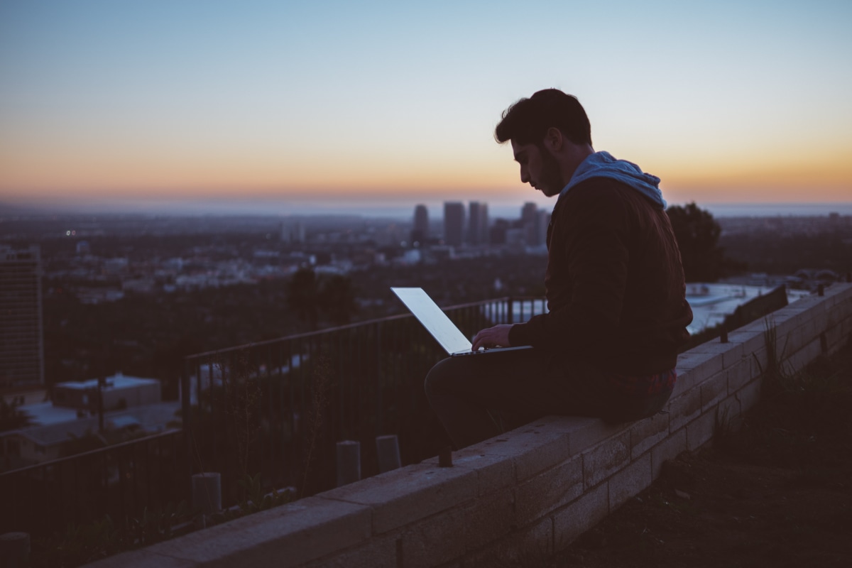 Man working overlooking city