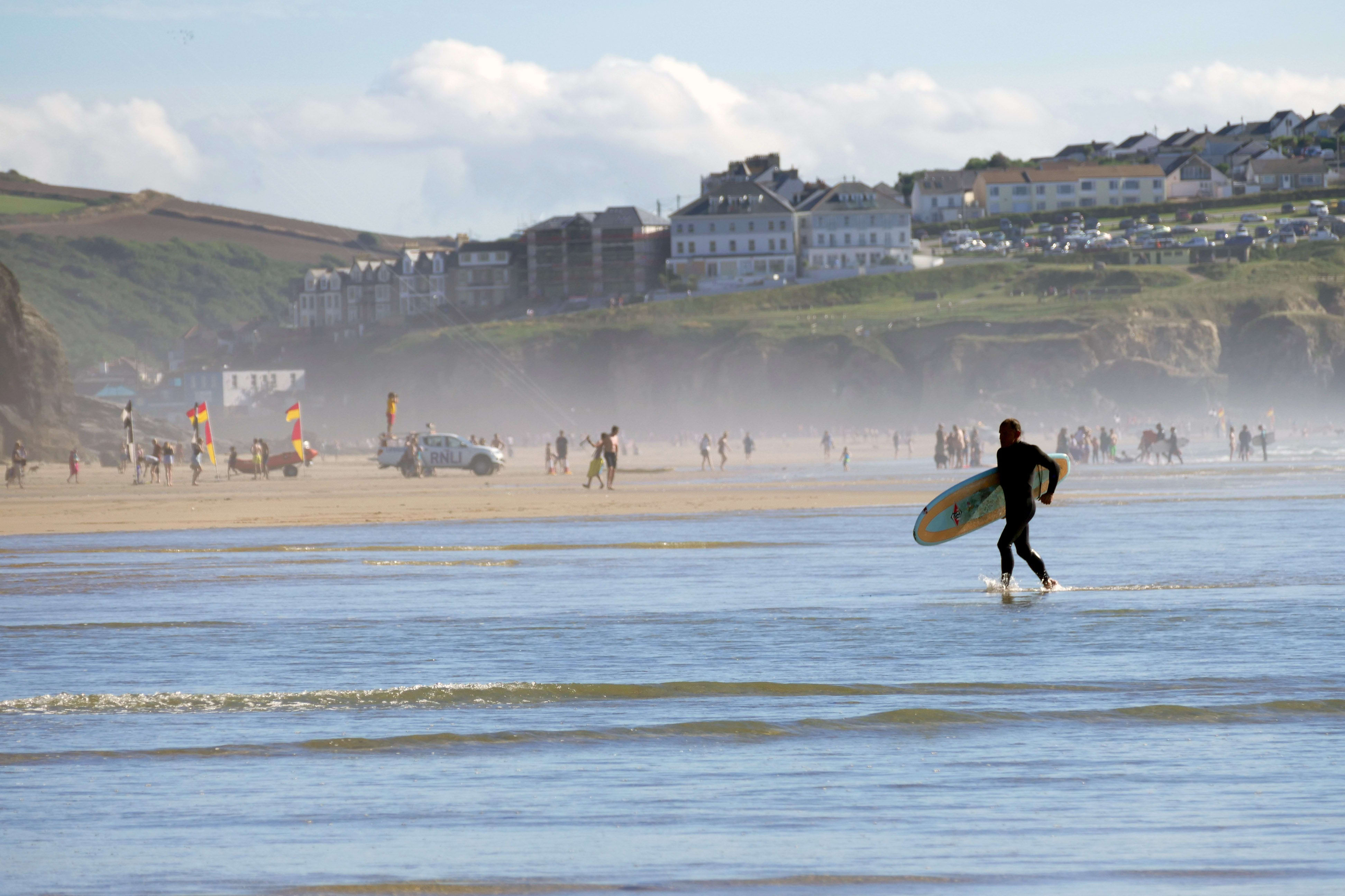 Go surfing in Littlehampton man with surf board