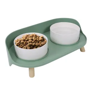 A modern green pet bowl that is double raised and designed for comfort.