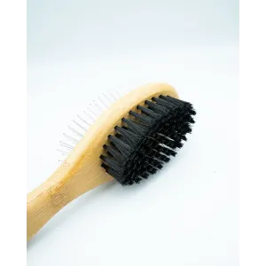 Bamboo Double-Sided Pin Brush on its side displaying the soft bristles with bamboo handle