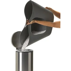 cat litter tray with litter being poured into dustbin to be disposed of