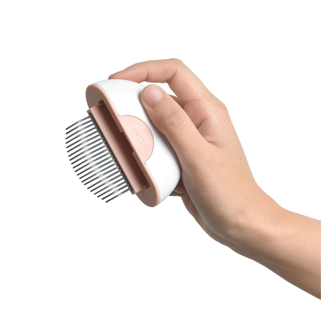 Hand holding one side of the comb