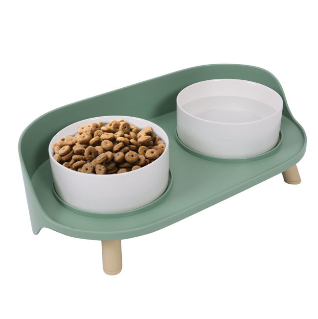 A modern green pet bowl that is double raised and designed for comfort.