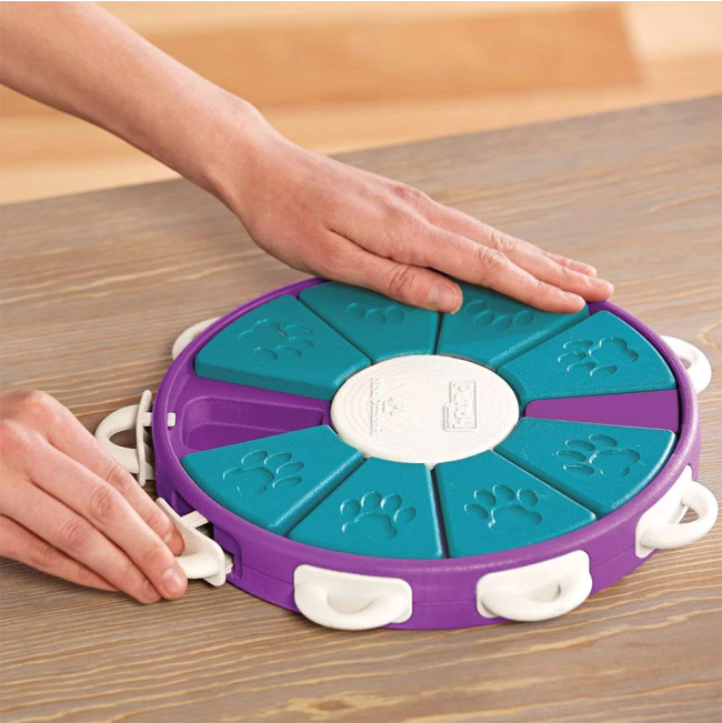 person showing how to use the dog twister toy