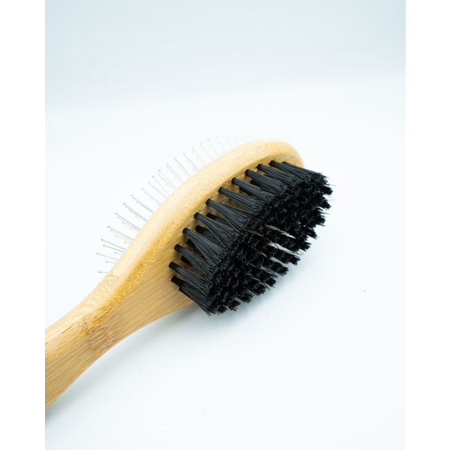 Bamboo Double-Sided Pin Brush on its side displaying the soft bristles with bamboo handle