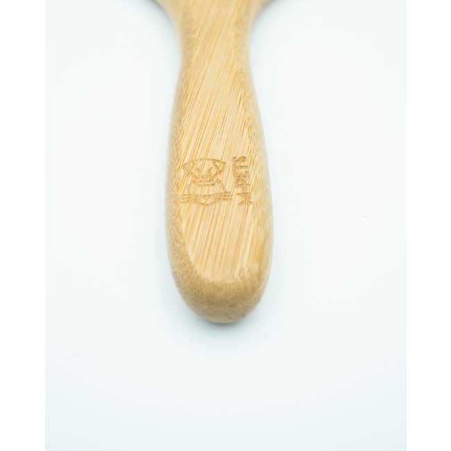 Bamboo Rake Comb for Dogs close up of bamboo handle