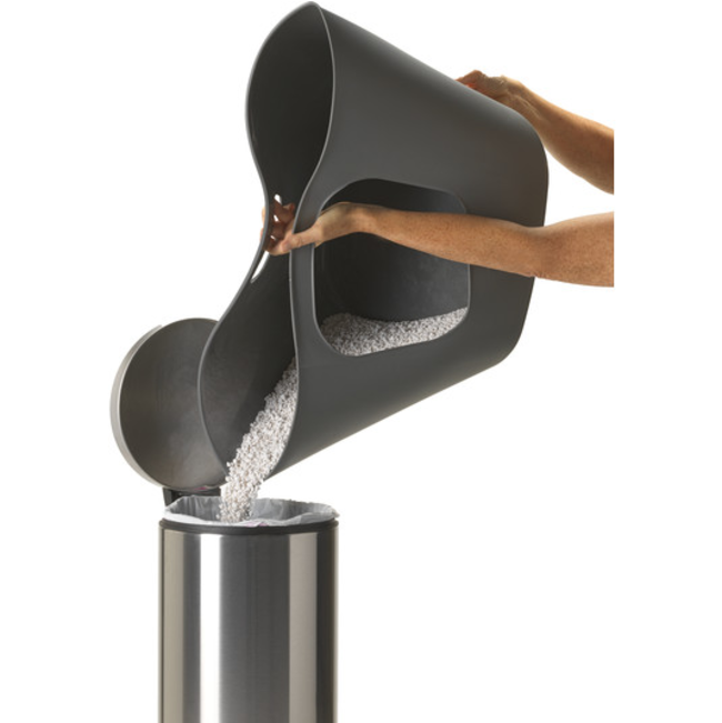 cat litter tray with litter being poured into dustbin to be disposed of