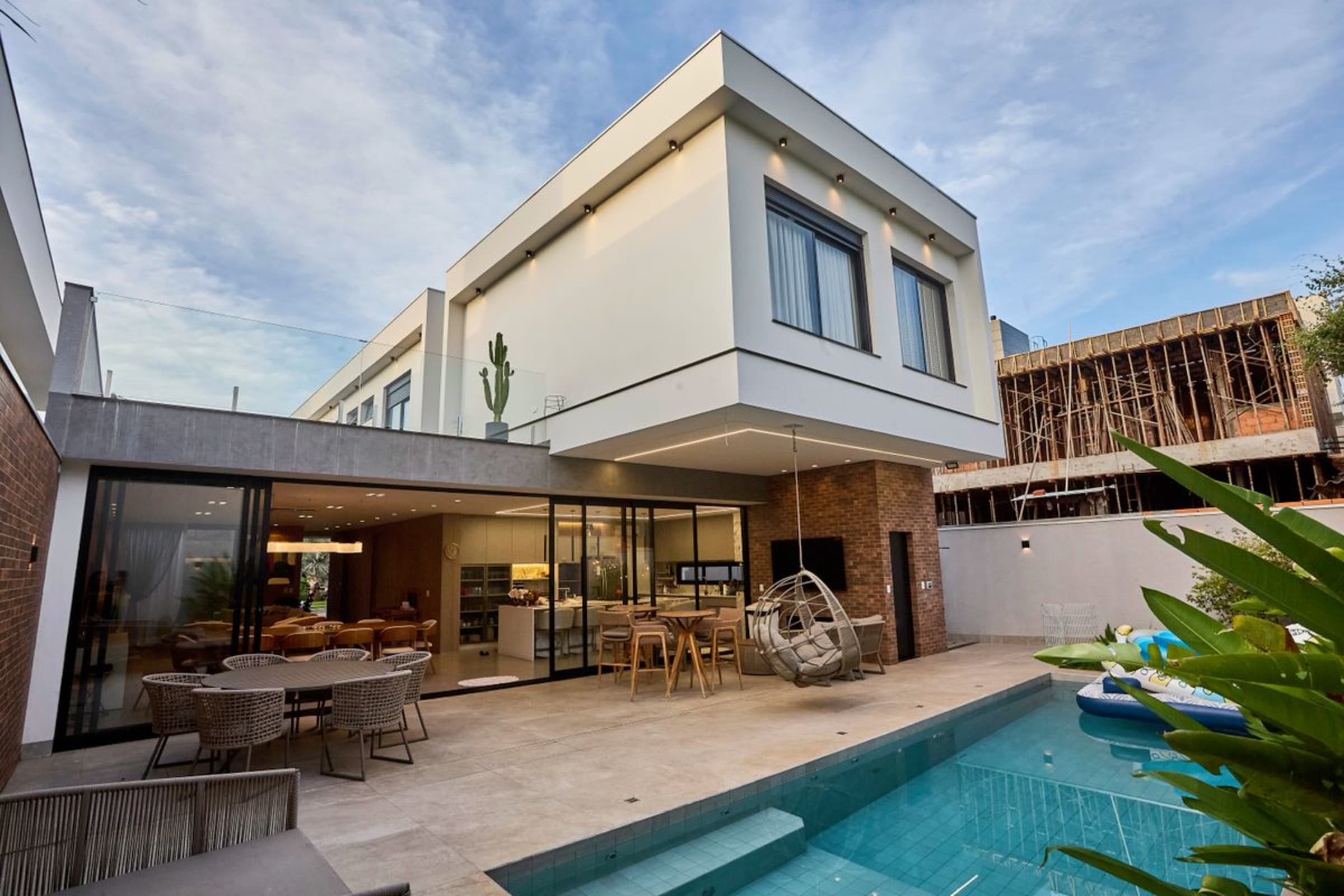 Modern home opening onto a landscaped pool terrace