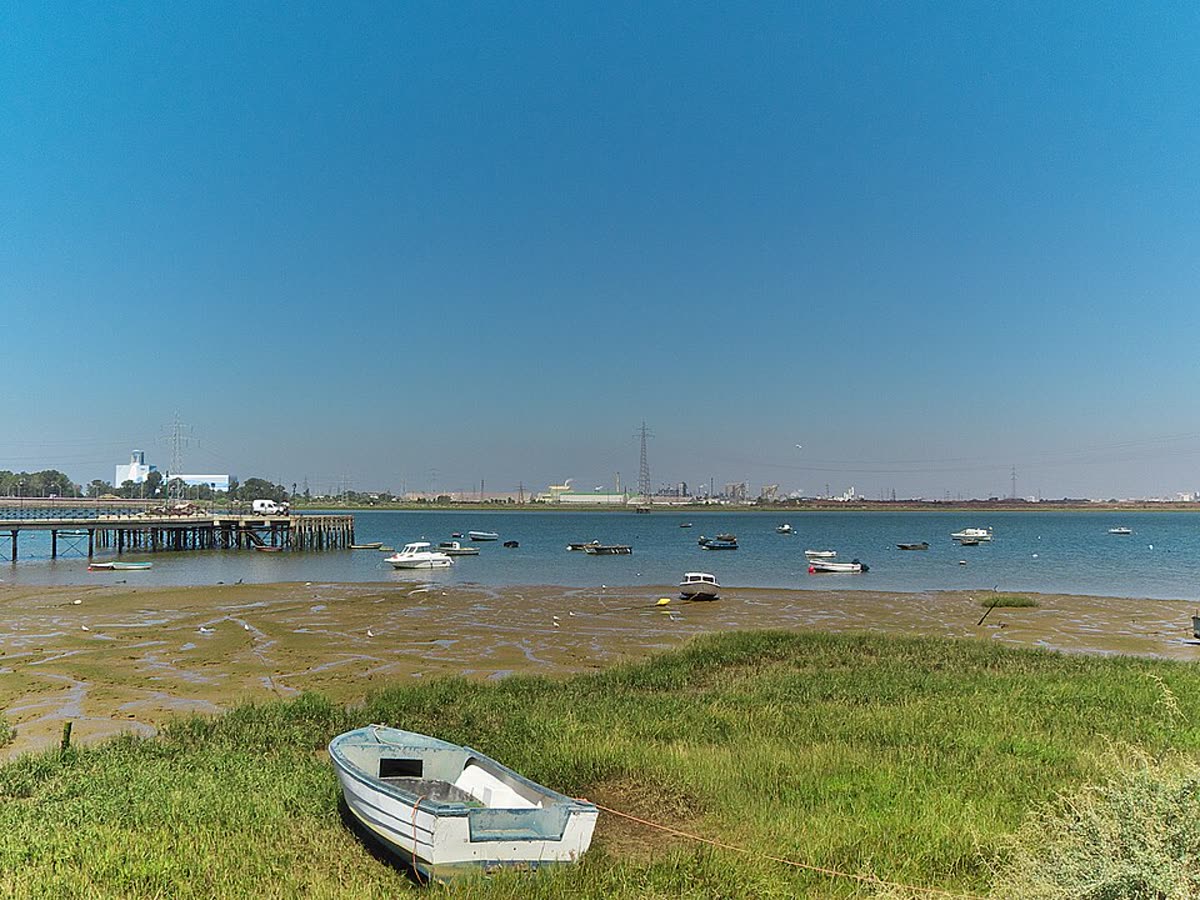 La ría de Huelva en la confluencia de los ríos Tinto y Odiel, con el perfil industrial de la ciudad al fondo