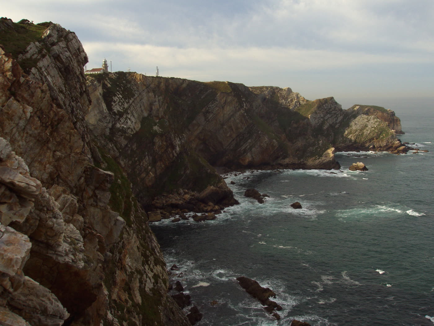 Acantilados del Cabo de Peñas con el faro al fondo, sobre el mar Cantábrico
