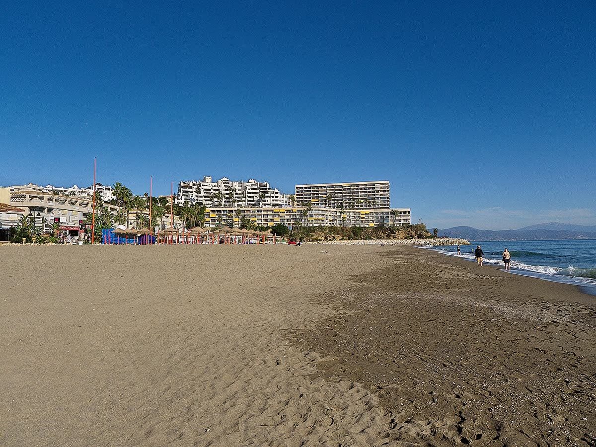 Playa de la Carihuela y el paseo marítimo de Torremolinos, con la sierra al fondo