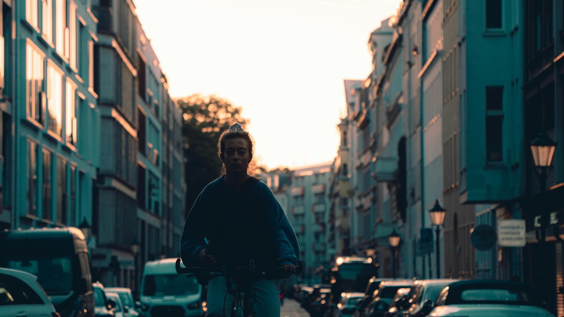 Radfahrer-Silhouette in Berlin im farbigen Sonnenuntergang – Stadtbike in Berlin mit Quipleon