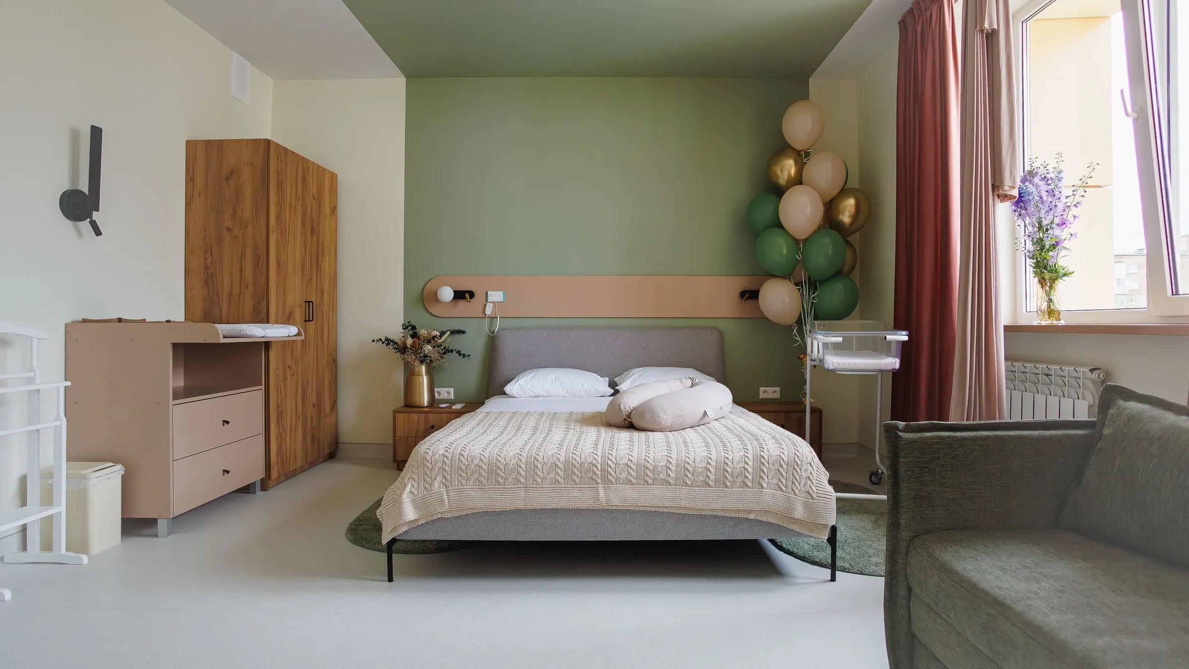 Maternity ward room with balloons and cot