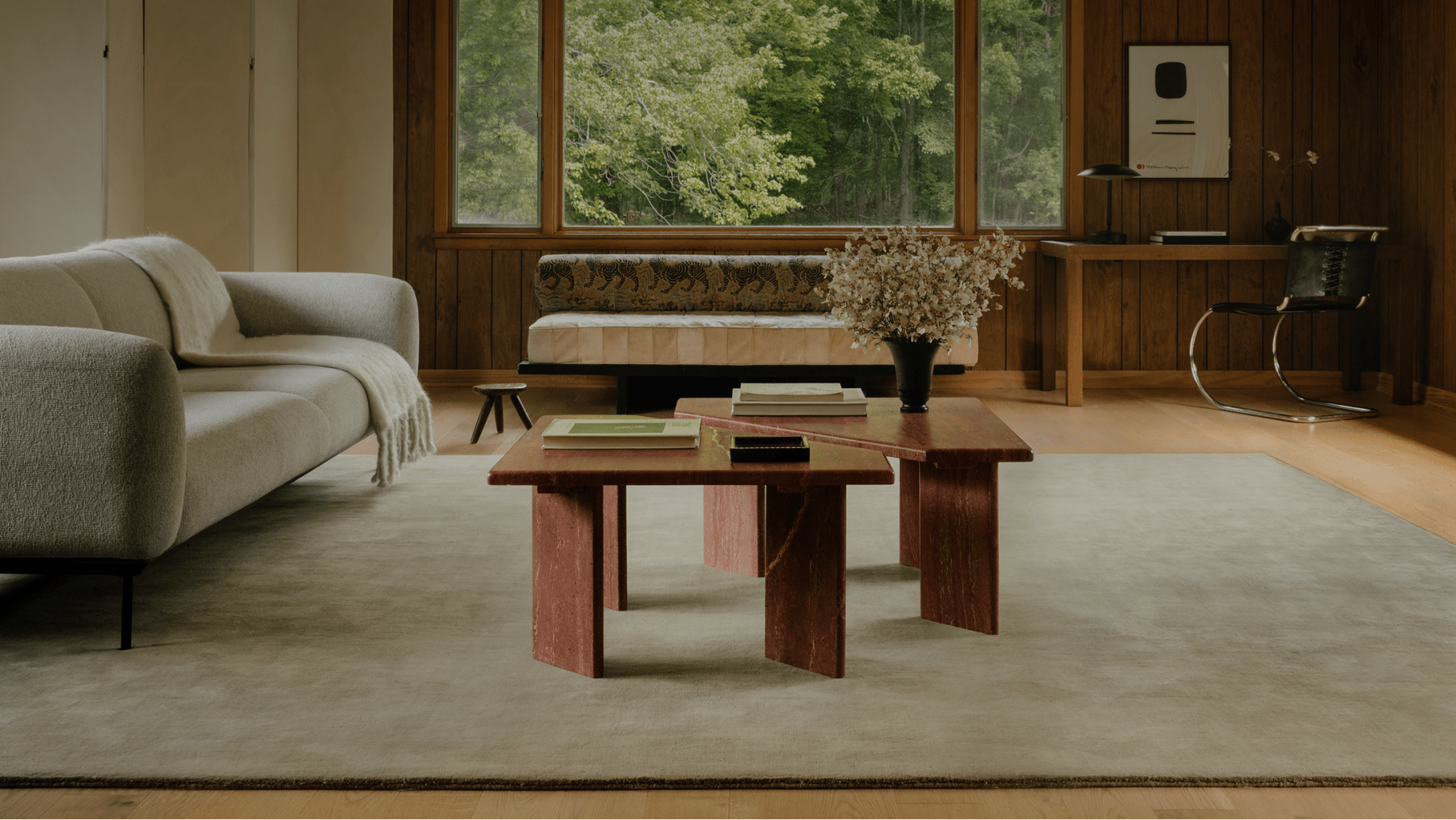 Living room with wood-panelled walls featuring a custom Earth Tones rug