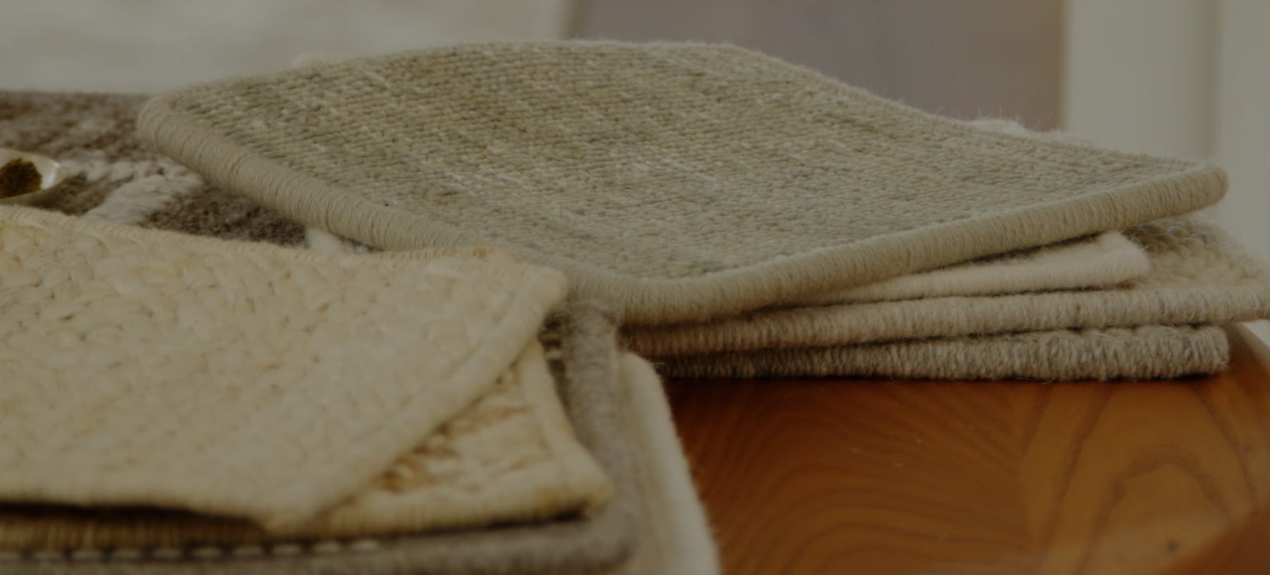 Sample swatches for luxury custom area rug displayed in elegant home interior