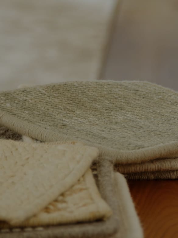 Sample swatches for luxury custom area rug displayed in elegant home interior