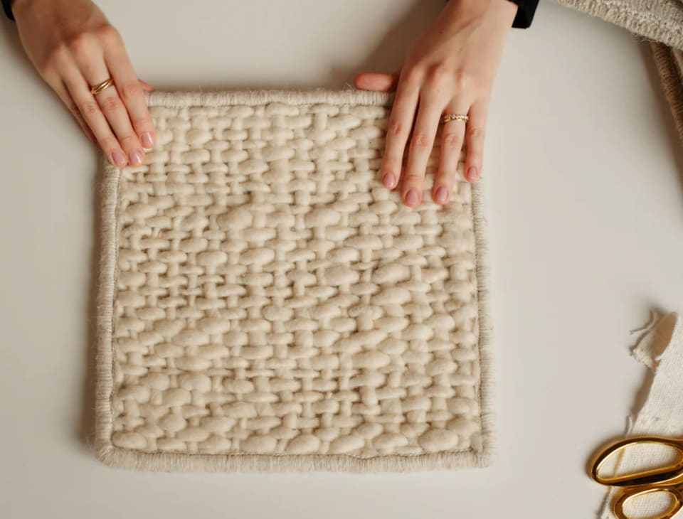Person handling a rug sample