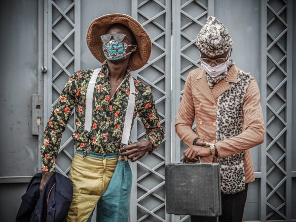 A couple of elegant young men wearing face masks.