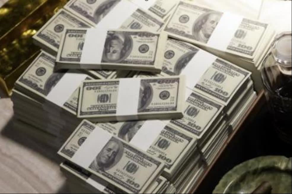 Stacks of US hundred-dollar bills arranged on a table, symbolizing wealth, cash abundance, and financial success.