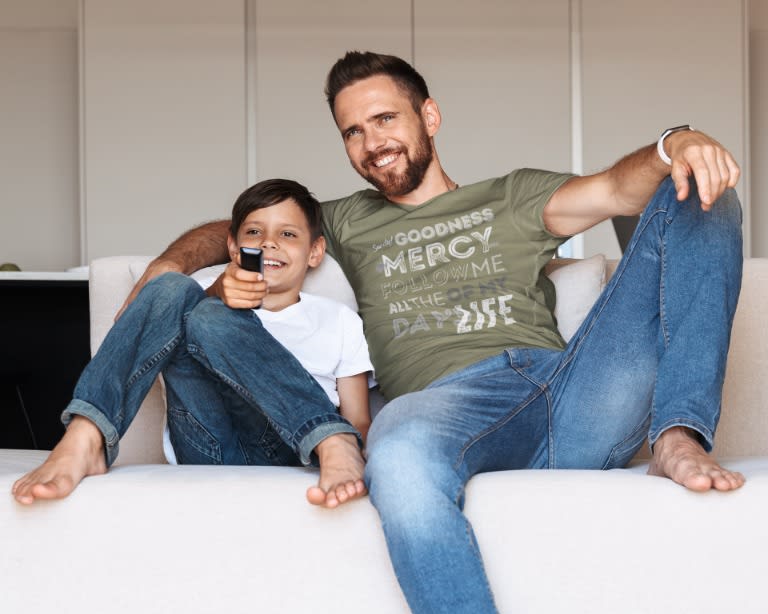 man watching tv with son in olive Goodness & Mercy CLASSIC Newsprint Christian tee
