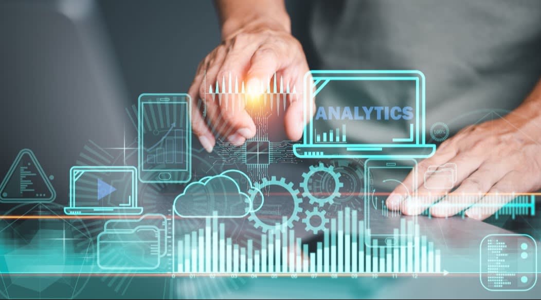 A person interacting with a digital interface displaying analytics icons, such as graphs, gears, cloud storage, and devices, symbolizing data analysis and technology integration.